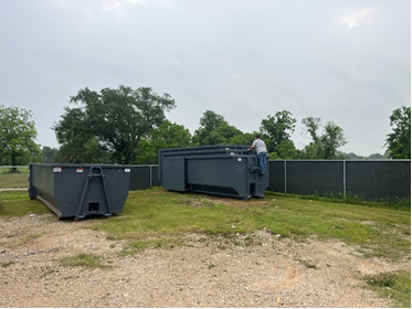 The 54" Hook Height: Each dumpster is equipped with a standard 54-inch cable lift pull-hook, aligned perfectly so that the truck’s hoist can secure the entire stack safely.